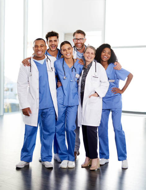 Working closely together to keep you well Portrait of a diverse team of doctors standing together in a hospital group of people standing together stock pictures, royalty-free photos & images