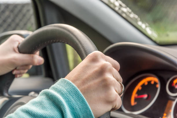 istock Woman holds the steering wheel tight while driving 1009970126