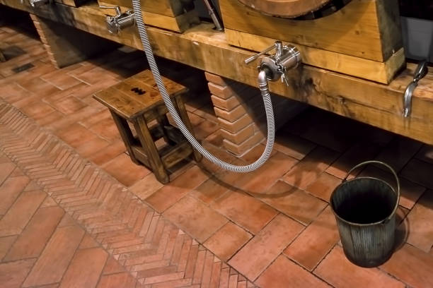 istock Dirty bucket next to a wine barrel in the cellar 1009973744
