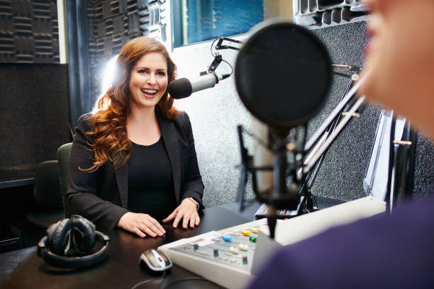 Broadcasting by the best in the business Shot of a young woman working in a recording studio radio broadcasting photos stock pictures, royalty-free photos & images