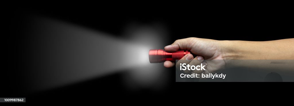 hand holding red flash light hand holding red flash light with growing lighting isolated on black background with clipping path Flashlight Stock Photo
