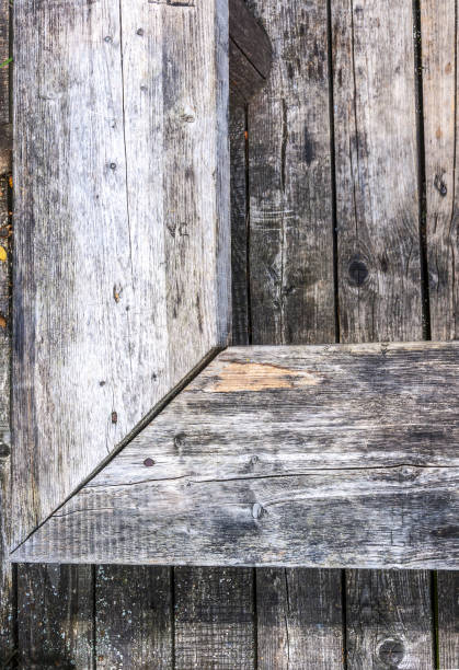 Aged gray nonpainted surface wooden bench and planks texture background stock photo