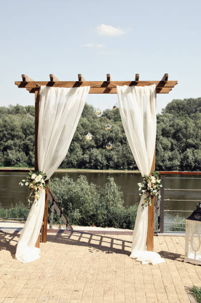istock wedding arch on the river bank 1009993552