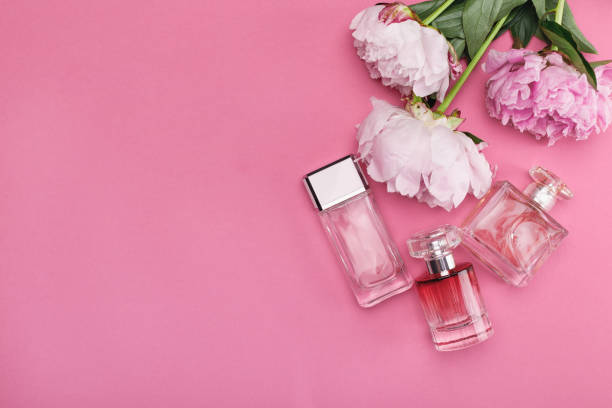 istock bottle of perfume and peony flowers 1010002064
