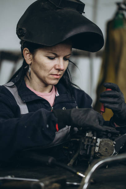 istock Man worker in motorcycle repair shop 1010002360