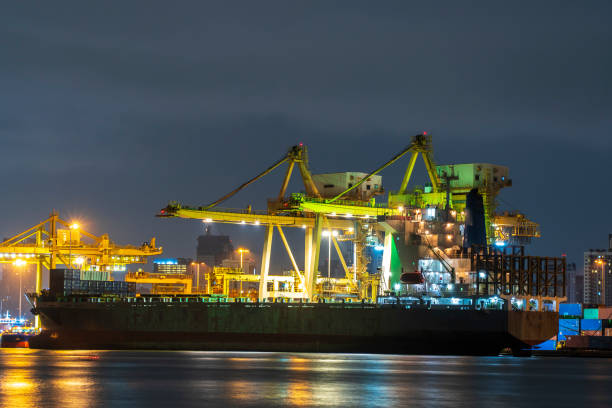 istock Container cargo ship working at night. import export business logistic and transportation 1010011100