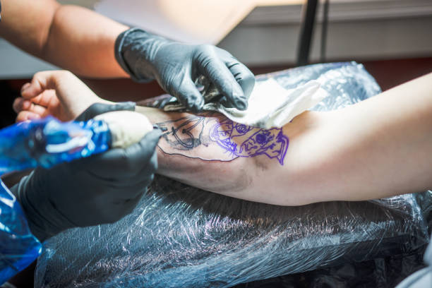 istock Young woman getting a tattoo done on her arm 1010014924