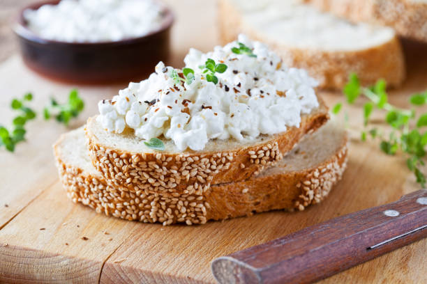 Cottage Cheese Appetizers Slice of bread with fresh cottage cheese and oregano cottage cheese photos stock pictures, royalty-free photos & images