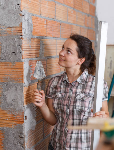 istock Woman working with plastering trowel 1010022508