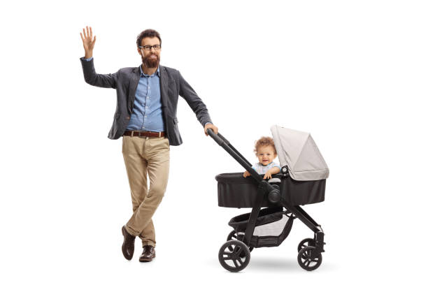 istock Father with a baby boy in a stroller waving at the camera 1010022816