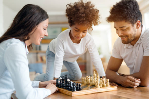 istock Happy family playing chess together at home 1010022984