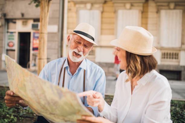 istock Joyful couple looking at touristic map 1010023208