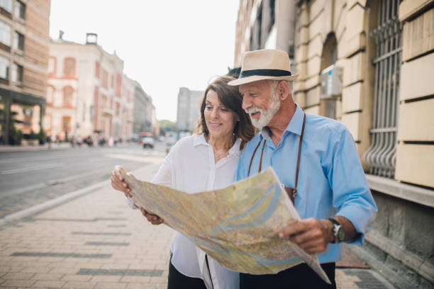 istock Smiling tourists looking at the map 1010023358