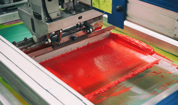 istock Red section of the screen printing machine, textile roundabout 1010023974