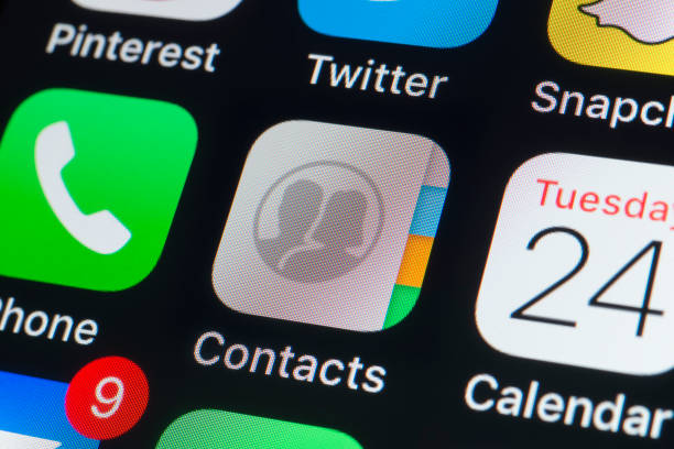 Apple Contacts, Calendar,Phone and other Apps on iPhone screen London, UK - July 24, 2018: The buttons of the Apple app Contacts, Calendar, Phone, Pinterest, Twitter, Snapchat and other apps on the screen of an iPhone. address book stock pictures, royalty-free photos & images