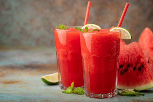 istock Watermelon slushie with lime, summer refreshing drink in tall glasses on a blue rusty background. with copy space 1010028478