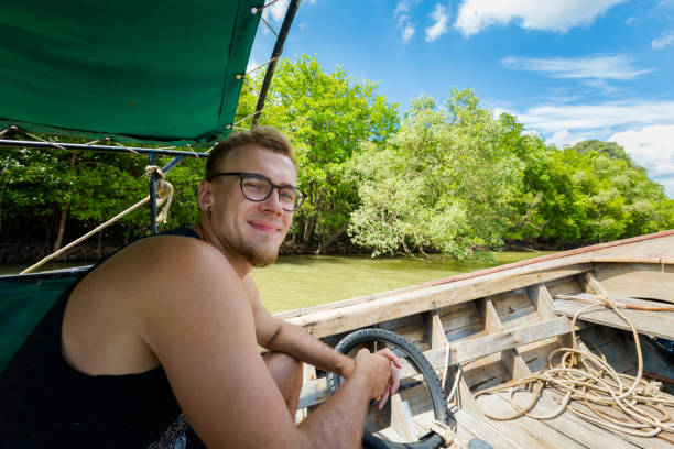 istock Man on longtail boat Thailand 1010031954