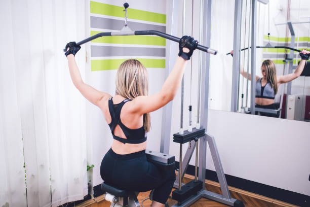 istock Woman working out on weight lift machine 1010032344