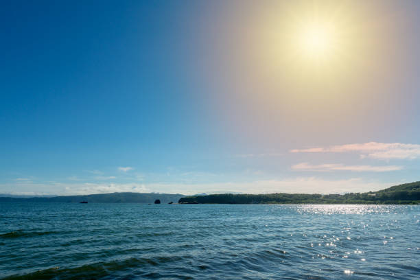 istock Orange yellow summer sun above calm waters 1010036902