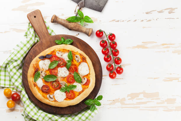 Italian pizza with tomatoes, mozzarella and basil. Top view with space for your text