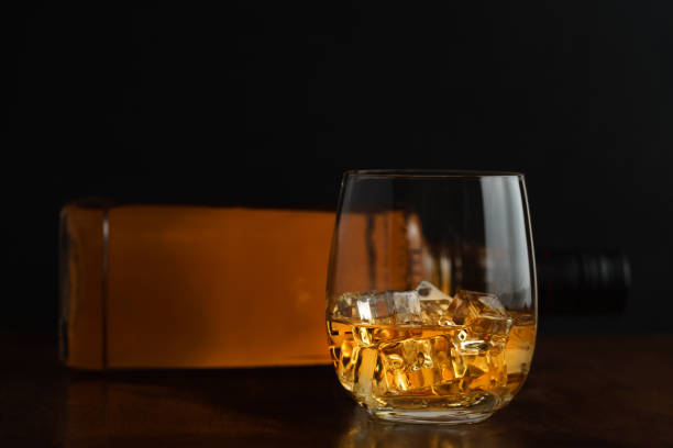 istock Glass of whiskey and it's bottle 1010051504