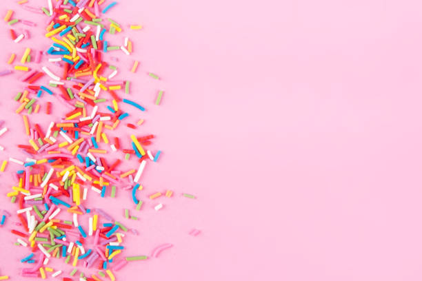 istock Sugar sprinkle dots hearts, decoration for cake and bakery, as a background. Isolated on pink. 1010055220