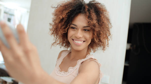istock Attractive young black woman making selfie in the kitchen. 1010059300