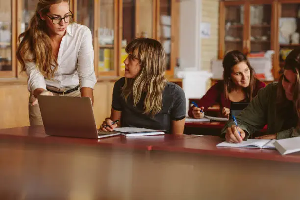 Photo of Teacher with students during her class