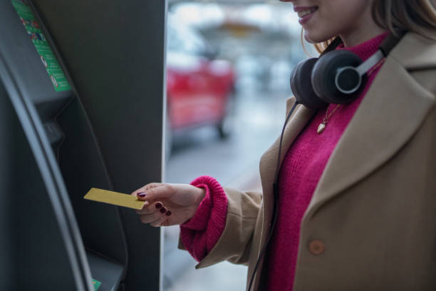 istock Woman taking money from ATM 1010060158