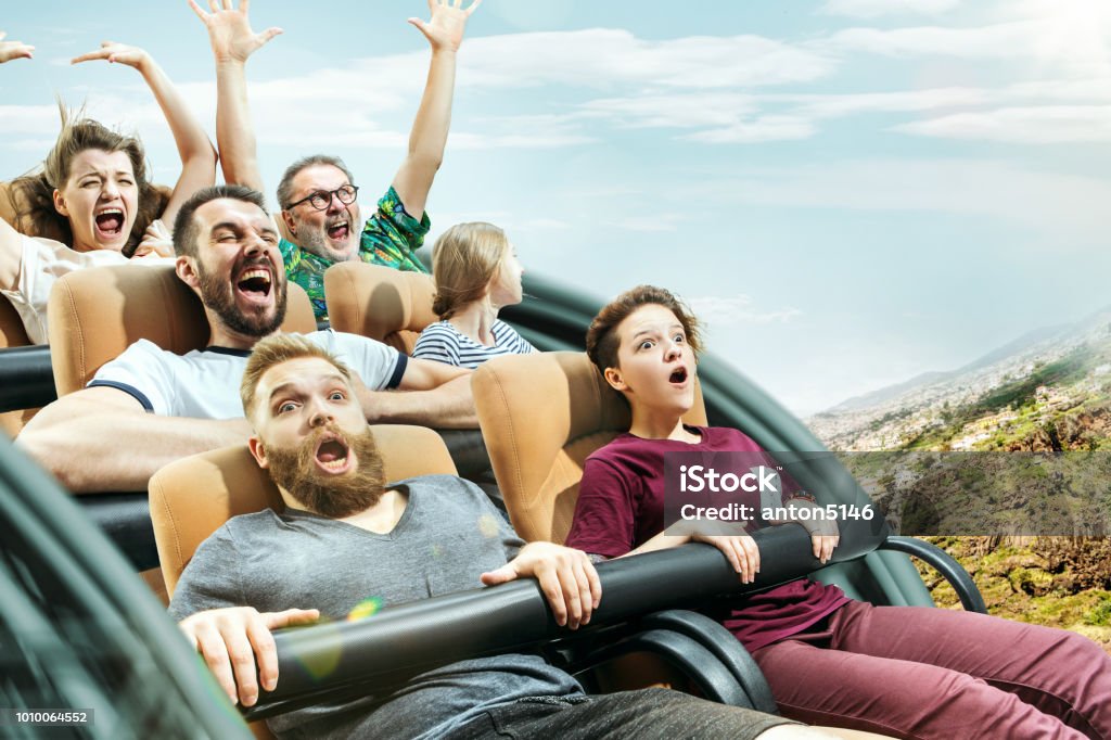 The happy emotions of men and women having good time on a roller coaster in the park The happy emotions of men and women having good time on a roller coaster in the park. Human emotions concept. Collage Rollercoaster Stock Photo