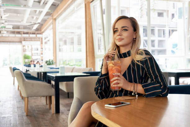 istock Young woman having good time while sitting in a modern cafe 1010064902