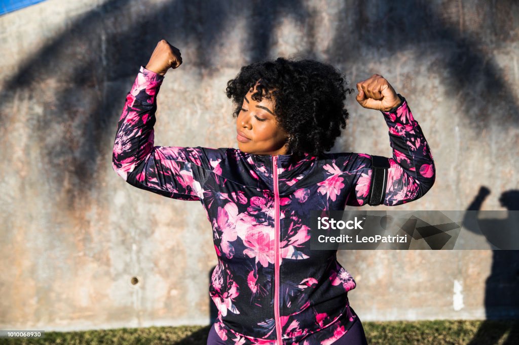 Funny portrait of a young black curvy woman during a training session Body Positive Stock Photo