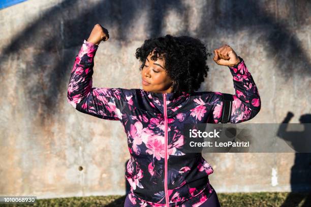 Funny Portrait Of A Young Black Curvy Woman During A Training Session Stock Photo - Download Image Now