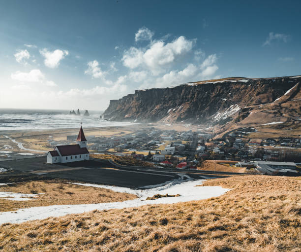 panoramic view of the vik at sunrise sunset . south iceland.typical red colored wooden church in vik town, iceland in winter - sky sea town looking at view imagens e fotografias de stock