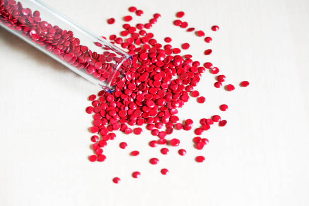 istock close up of red industry plastic pellete polymer granules background 1010071836