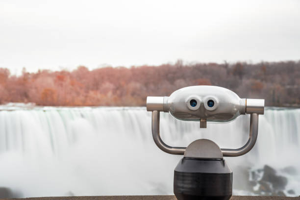 istock Stylish Tourist Binocular with a Waterfall in a Background on A Fall Day 1010074636
