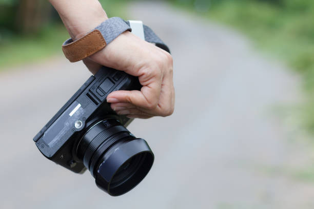 istock Woman phtographer hand holding digital camera 1010078044