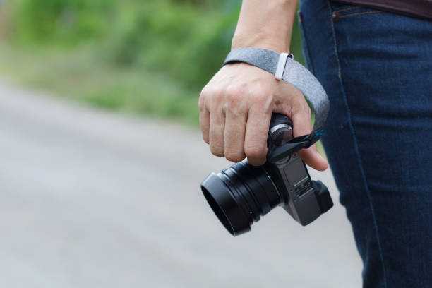 istock Woman phtographer hand holding digital camera 1010078546