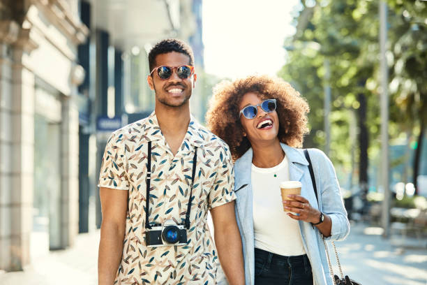 istock Cheerful young couple walking on sidewalk in city 1010078570