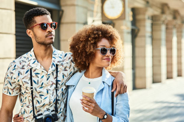 istock Couple with arm around looking away on sidewalk 1010078592