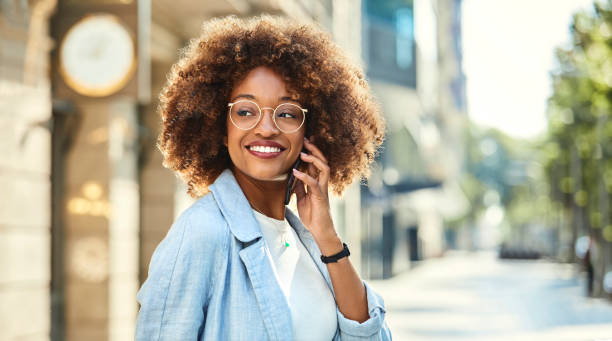 istock Woman using mobile phone at sidewalk in city 1010078618