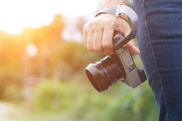 istock Woman phtographer hand holding digital camera 1010078664