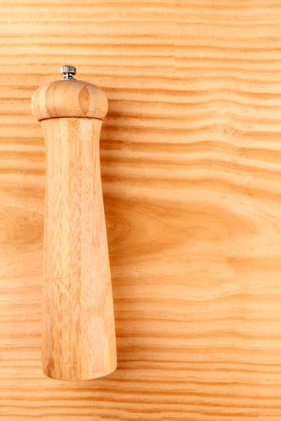 istock Vintage pepper grinder on a rustic wooden background with copy space 1010078872