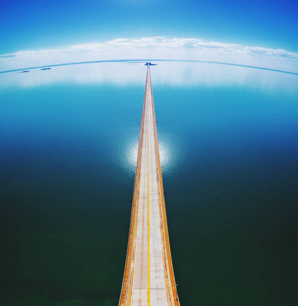 istock Aerial top view of a long highway bridge above a river. 1010092408