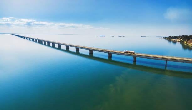 istock Aerial view of a long highway bridge above a river. 1010092452