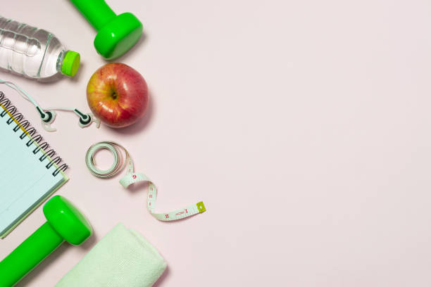 istock Top view flat lay healthy object with dumbbells, bottle water apple for sport or exercise concept. 1010098848