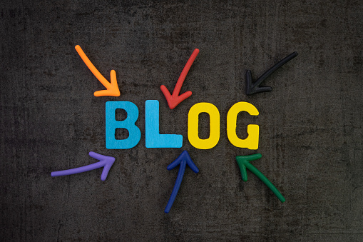 Blog, web logs online article and website concept, colorful arrows pointing to the word BLOG at the center of black chalkboard wall, new job for writing article and publish to the internet.