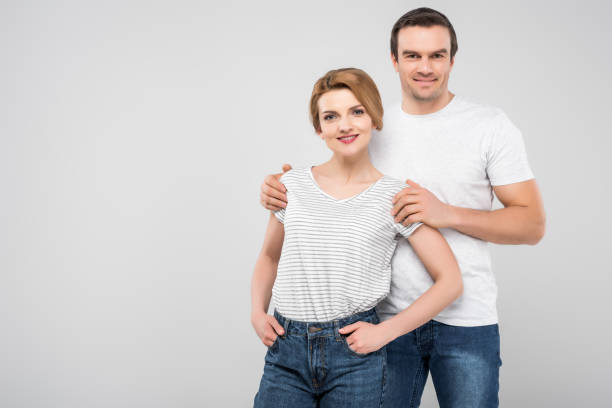 istock smiling husband hugging his wife, isolated on grey 1010099508