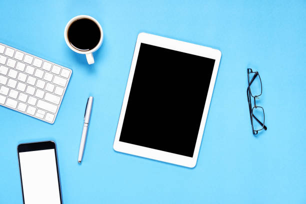 istock Top view, Modern workplace with tablet with smart phone placed on a pastel blue background. Copy space suitable for use in graphics. 1010099616