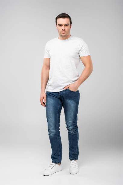 istock handsome man with hand in pocket looking at camera, isolated on grey 1010099724